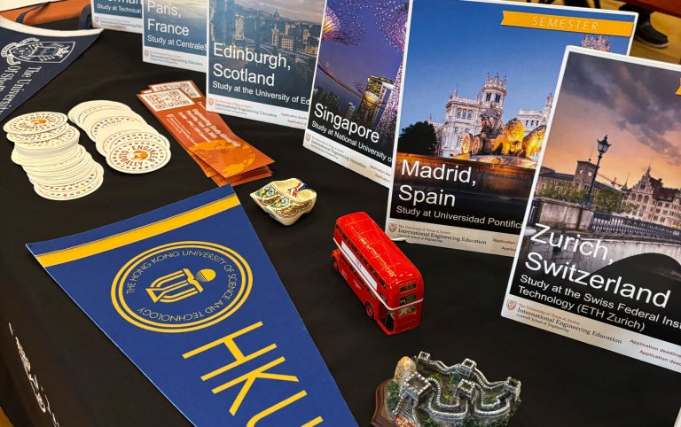 Education Abroad Fair table display with location brochures about exchange programs
