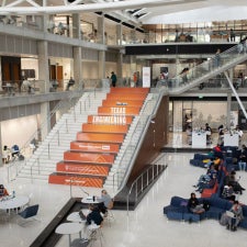 The thoughtfully designed massive open concept interior of UT Austin's Cockrell School of Engineering with the main staris in view
