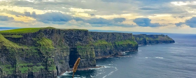 Green cliffs in Ireland by water