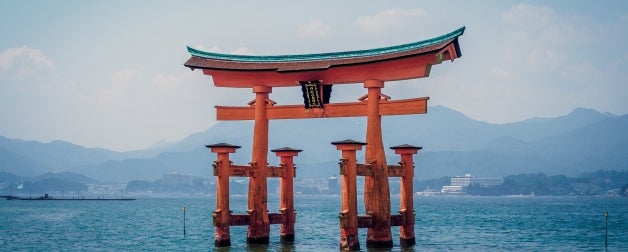 red structure in body of water near mountains during daytime