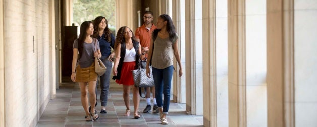 group of students walking though a courtyard on the UT Austin Campus