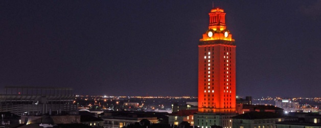 UT Austin tower lit up orange with No. 1 above Austin cityscape 
