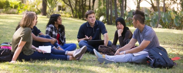 Students sitting and talking on the grass