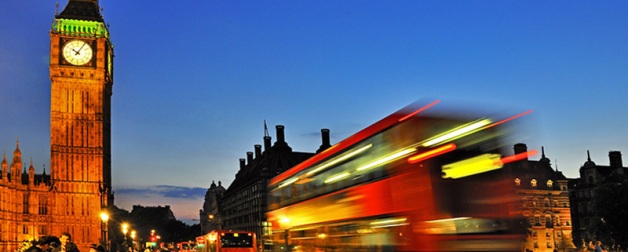 London street in the evening showing Big Ben clock and moving city bus