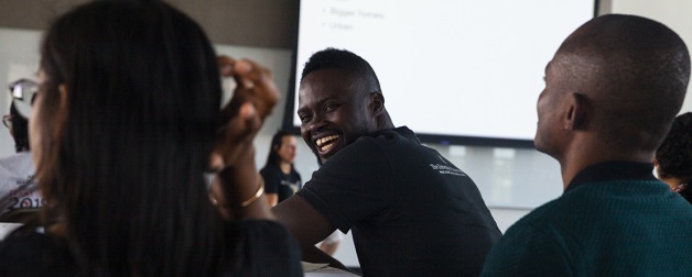 International students sit together smiling