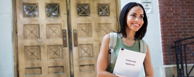 prospective female student looking full of hope with scholarship application folder