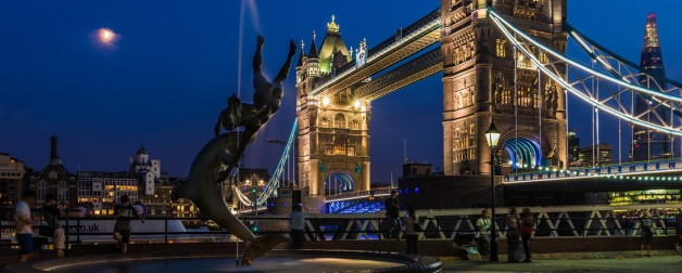 London Bridge from shore at night, fountain statue in foreground