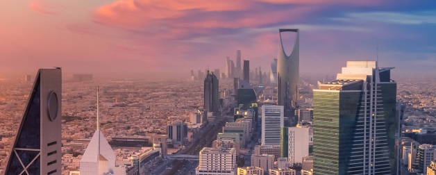 Riyadh skyline aerial shown against a gorgeous pink, blue, and purple sunset backdrop with the Tower Kingdom Center in view, Kingdom of Saudi Arabia