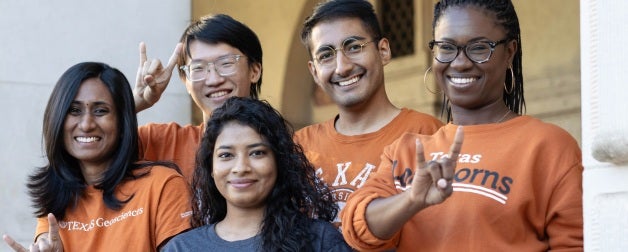 Smiling UT students show off their longhorn pride