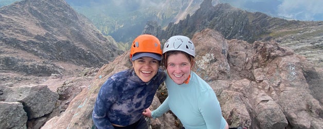 Members of UT Austin's Fulbright student program pose atop a mountain