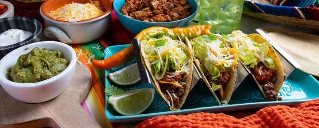 a colorful display of fresh tacos and toppings