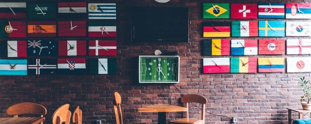 a globally oriented cafe with signs with flags of various countries from around the world