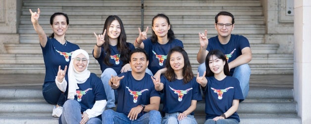 Texas Global exchange students pose in a group shot while showing of their Longhorn pride