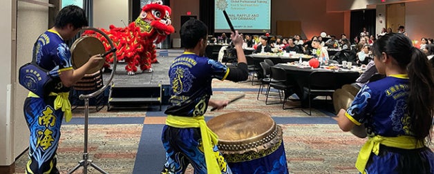 Performers from the Texas Southern Sea Dragon and Lion Dance Association danced onstage and moved from table to table, allowing students and guests to pet the giant “animals” costumed in red fringe.