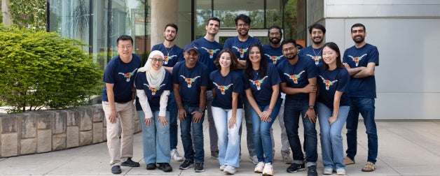 A group of ISSS students smile in front of the Texas Global main building