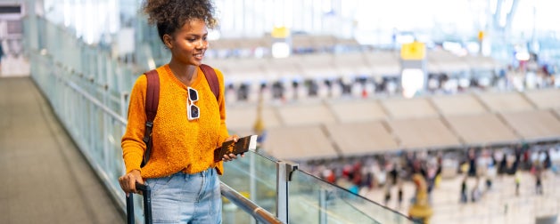 A female traveler traverses an airport