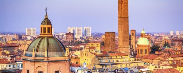 Historic buildings and church steeple in Bologna, Italy during the evening
