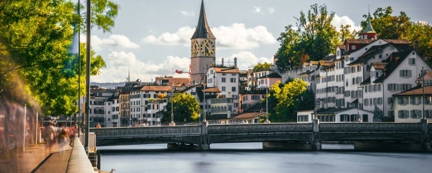 A beautiful view of the river and the historic buildings that line the city of Zurich, Switzerland