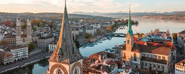 beautiful drone view in the morning of the historic buildings that line the river that runs through Zurich, Switzerland