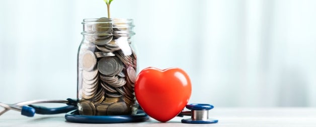 Money is a jar with a plant growing out it, beside it is a heart and stethoscope
