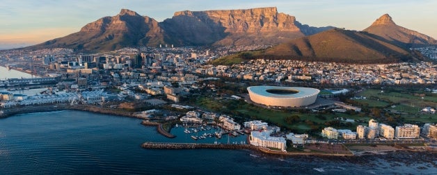 Aerial of Cape Town South Africa in the evening, mountains in the background tower above the city