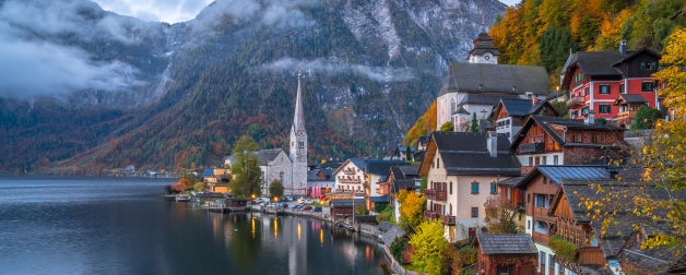 Scenic view of the famous historic Hallstatt mountain village in the Austrian Alps at twilight during blue hour at dawn in fall