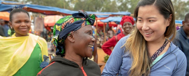 A young woman shares a smile with other local indigenous women in Tanzania, Africa