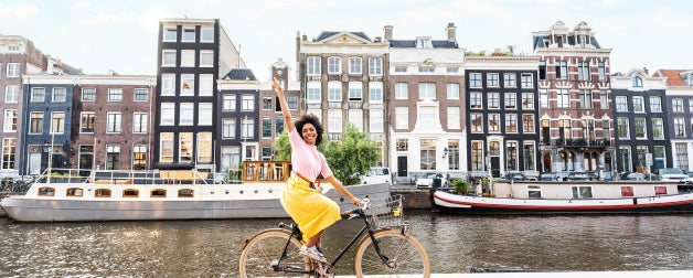 Student on bike on a canal