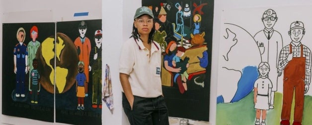 An artist poses with her work