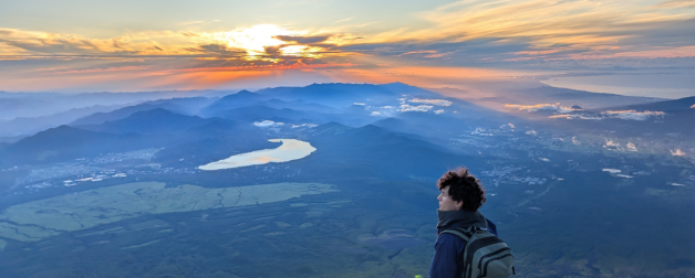 student hiker overlooking expansive mountains in Korea