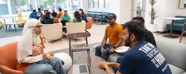 Students from different cultures dialogue together in the Texas Global lobby