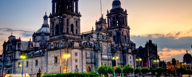 The Metropolitan Cathedral stands tall above Constitution Plaza at sunset in Mexico City, Mexico