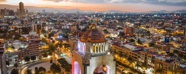 Aerial view of city center in Mexico City, Mexico, including historical landmark Monument to the Revolution located at Republic Square at dusk