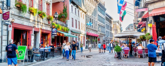People meander at the junction of Rue Saint-Paul and Rue Saint-Vincent in the Old Montreal section of Montreal, which are famous for restaurants and unique shops