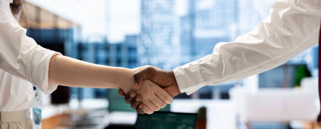 Recruiter shaking hands with person