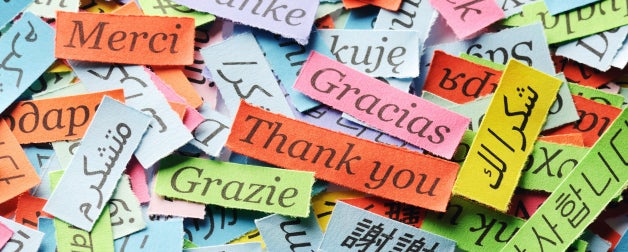 Different phrases in various languages on colorful pieces of paper
