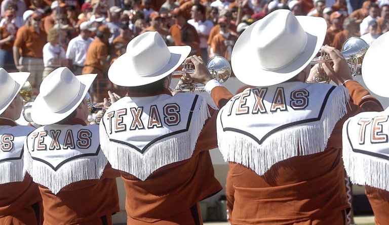 5 trumpeters from Longhorn Band show off their fringe and hats