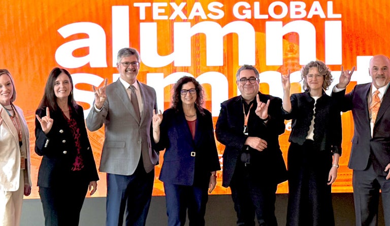 Deans and leaders from UT Austin show "Hook em" at the 2026 Alumni Summit
