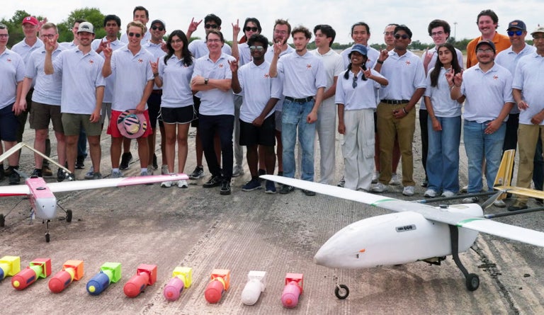 UT Austin's team for the XPRIZE Wildfire Competition stands behind the planes they built