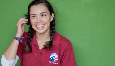a Peace Corps volunteer poses in her uniform in nicaragua