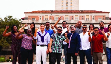 Young Leader of Americas fellows pose in front of UT tower 