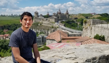 gabriel poses in front of the Kamyanets-Podilskyi Fortress