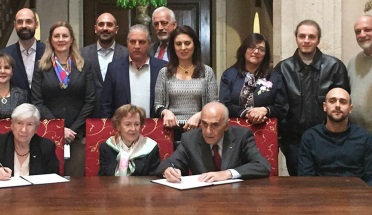 Munib (right) and Angela Masri (middle) signing a graduate fellowship endowment agreement with University of Texas at Austin Jackson School.