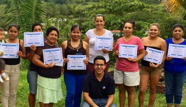 peace corps volunteers pose with their certificates