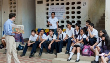 a peace corps volunteer teaches a group of students
