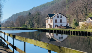 A serene cottage on a river in Saverne, France.