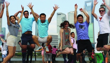UT Austin students jump for joy on the waterfront in Shanghai, China