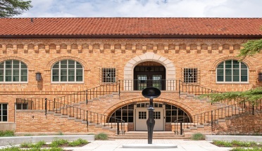 A 10-foot bronze sculpture in front of the historic women's gym on UT campus