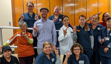 ELC instructor and custodial employees give the Hook 'em Horns 