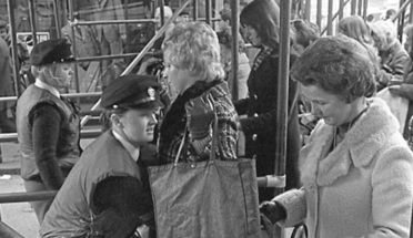 A woman checks in with police at a security point